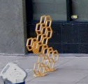 Yellow honeycomb-shaped bike racks by S. Central near Jefferson St.
